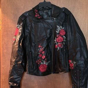 Torrid leather jacket with flower detailing.